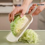 Feliator și tocător de varză | Ustensilă de bucătărie durabilă din oțel inoxidabil pentru prepararea salatelor | Mâner ergonomic, răzătoare și tăietor eficient de legume | Ideal pentru varză, castraveți, morcovi | Include recipient de depozitare | Perfect pentru gătit acasă